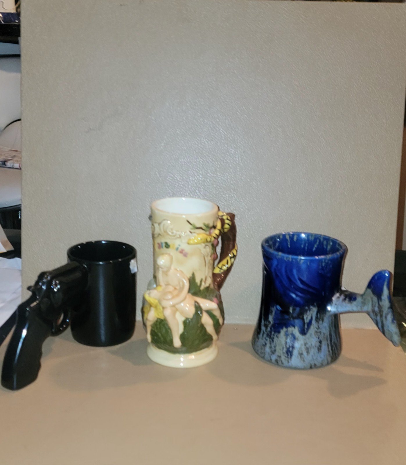 3 VINTAGE ASORTED CERAMIC CUPS REVOLVER HANDLE DOLPHIN AND NUDE COUPLE CUPS