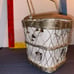 Ceramic dish with unique symbols enclosed in wire mesh basket