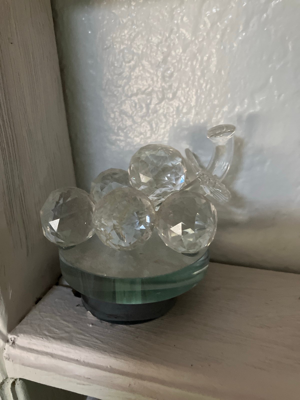 Glass grapes artwork on rotating platform