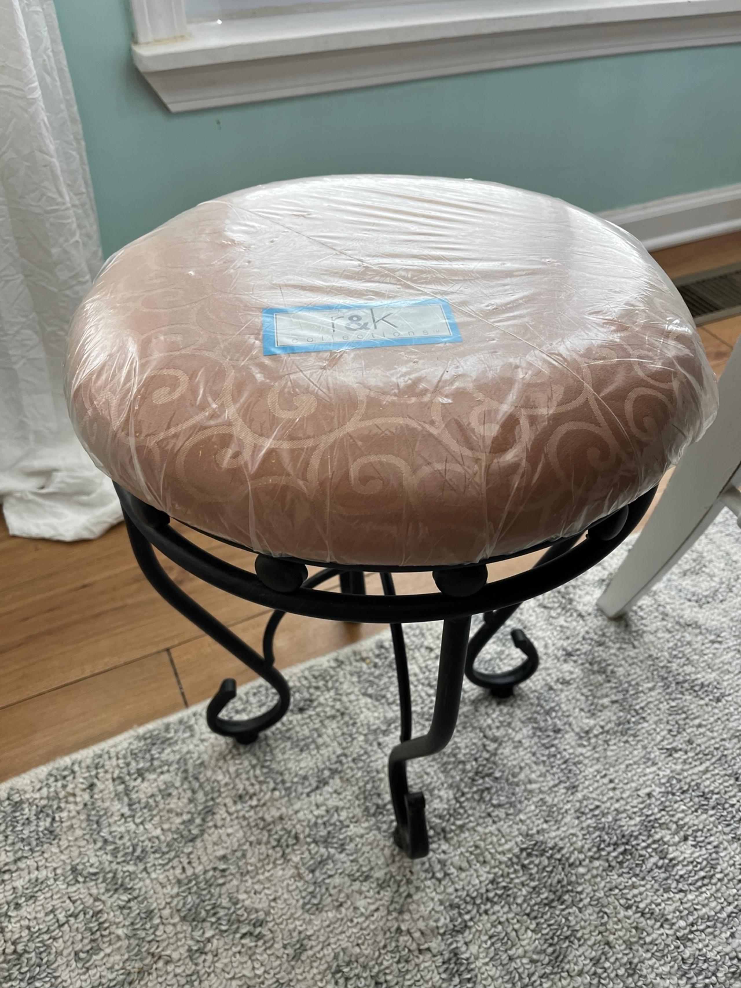 Brown and tan R&K upholstered vanity stool with iron base. Brand new!