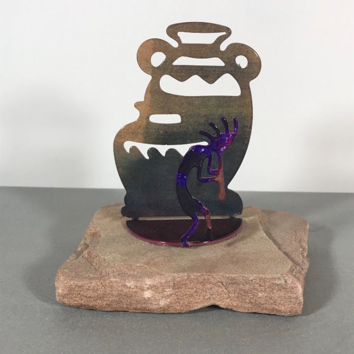 Metal Kokopelli & Native American Vases on Rock