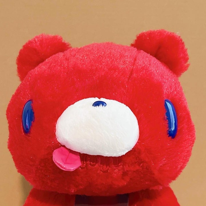 Chax Gloomy Bear Plush Laying Down Red Tone Blue Eye Sticking Tongue
