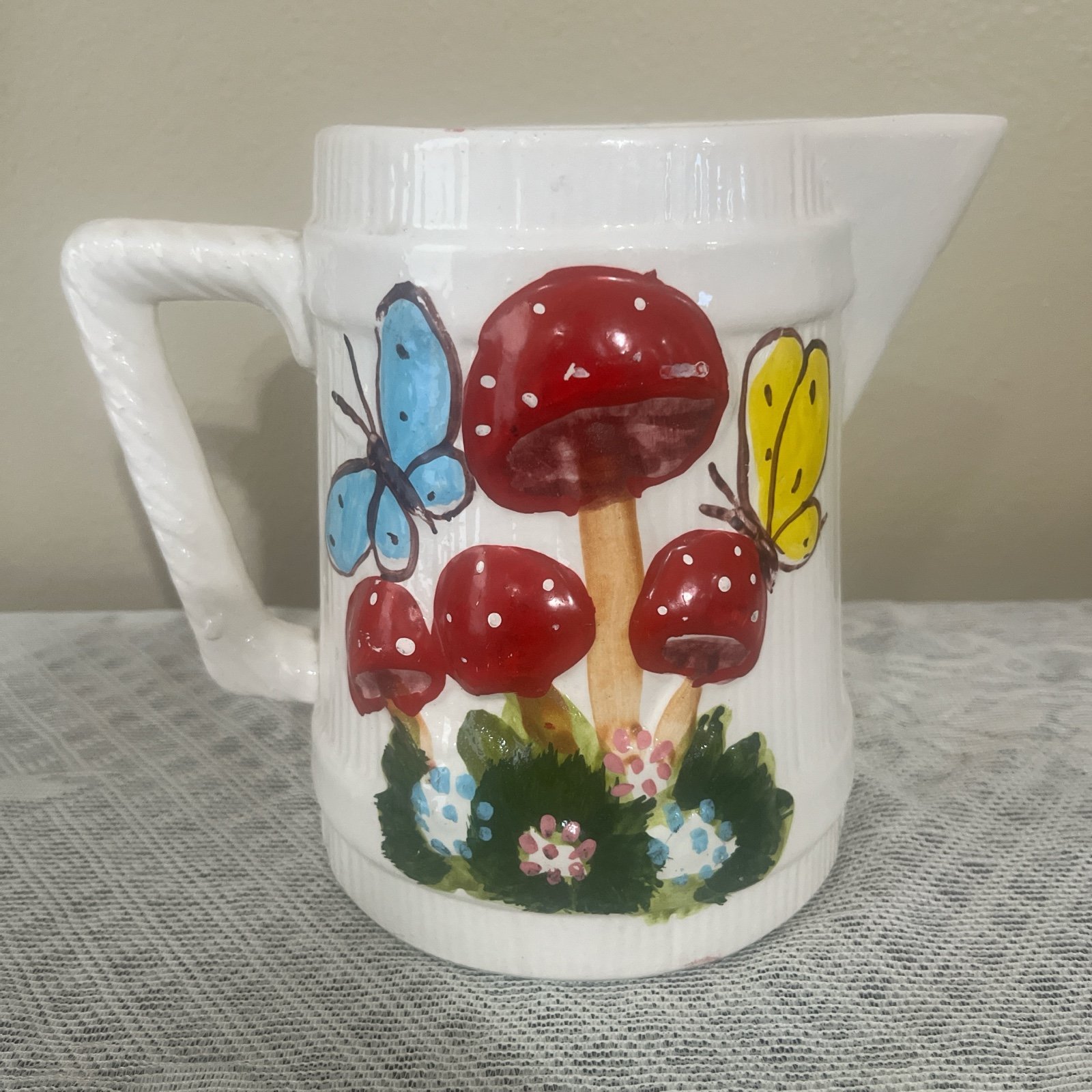 Vintage White and red ceramic pitcher with a butterfly and mushroom design!