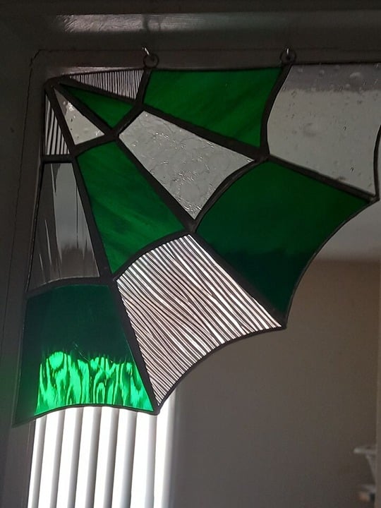 Stained glass dark forest green spider web corner
