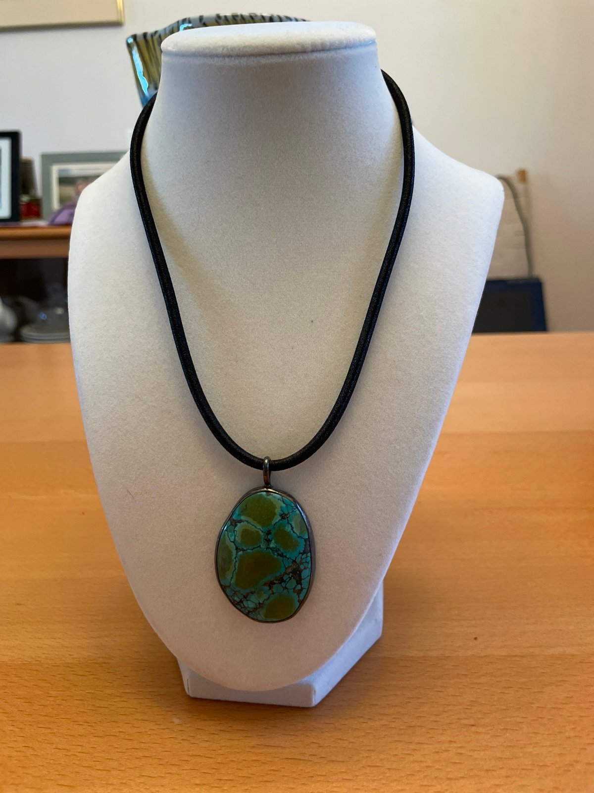 Turquoise necklace on heavy cord.