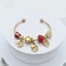 Linx Yellow Gold Open Bangle with Red and Gold Themed Charms