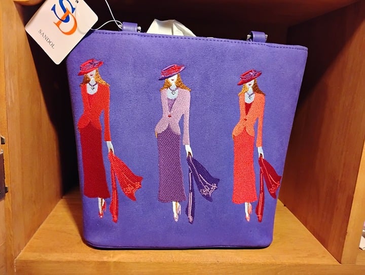 Sandol - Purple handbag with Full lady silhouette and red hat.