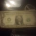 A one dollar bill with the numbers 02222212