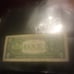 A one dollar bill with the numbers 02222212