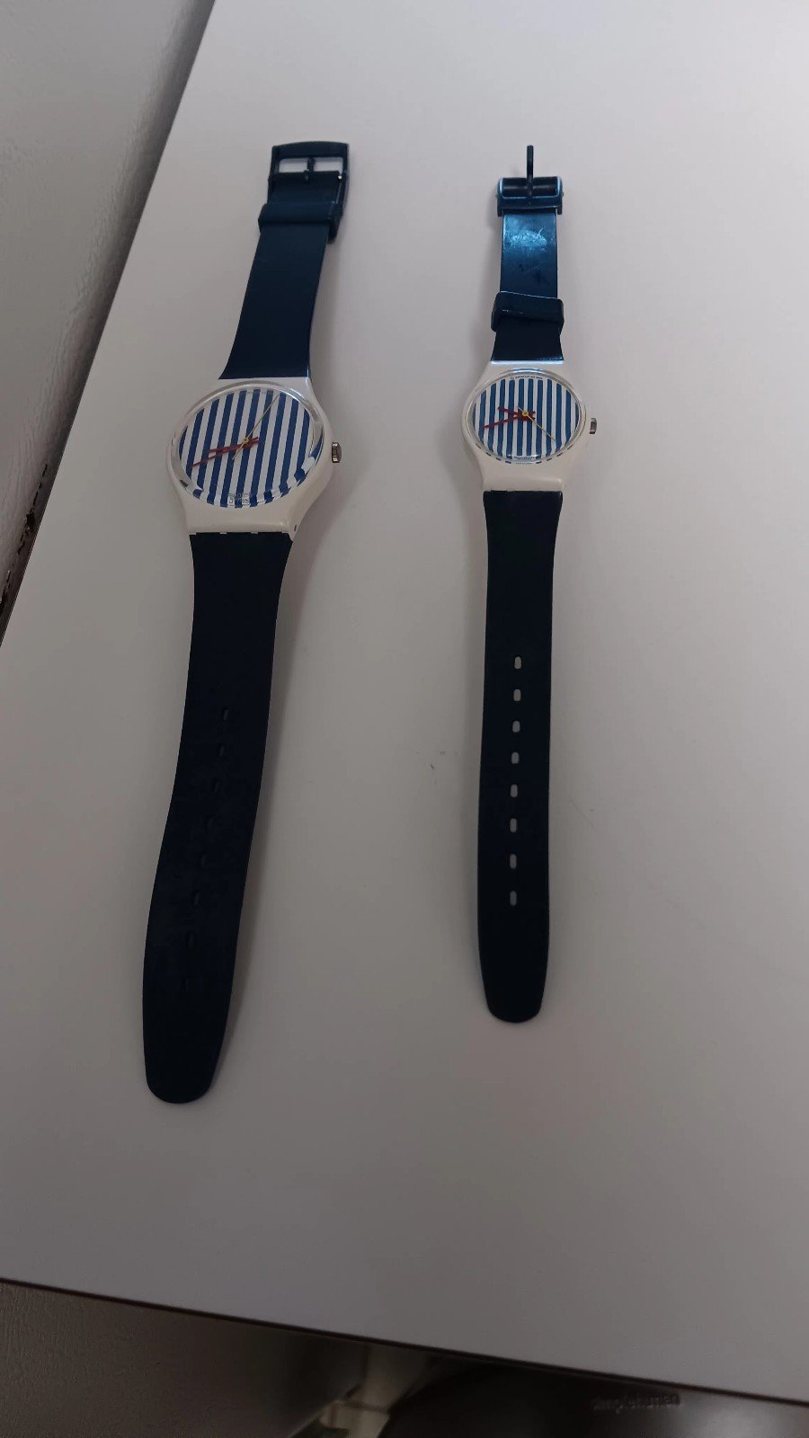 1 smaller Swatch watch