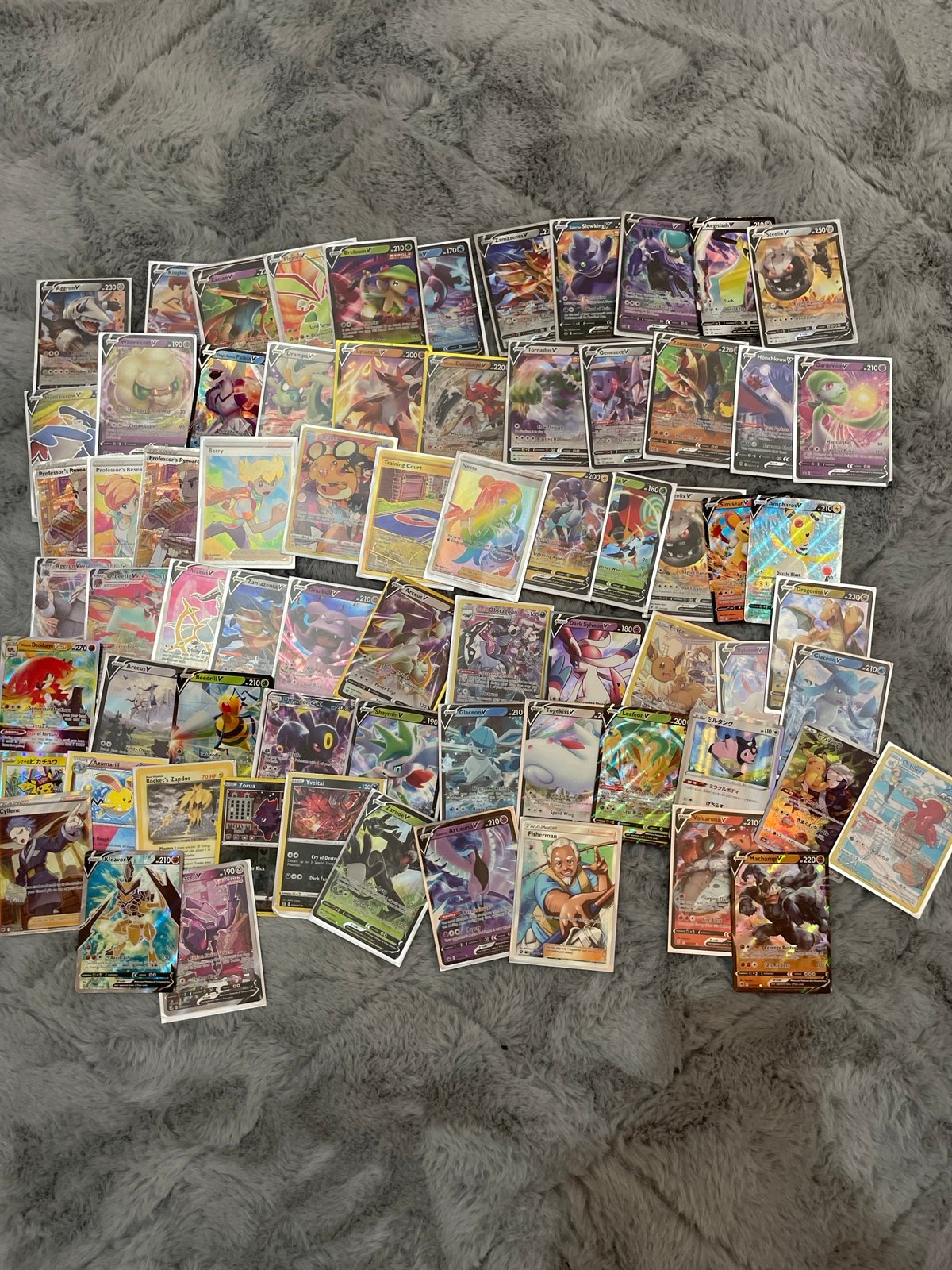 About 70 pokemon cards with trainers,vmax,v,alternate arts, and tag teams