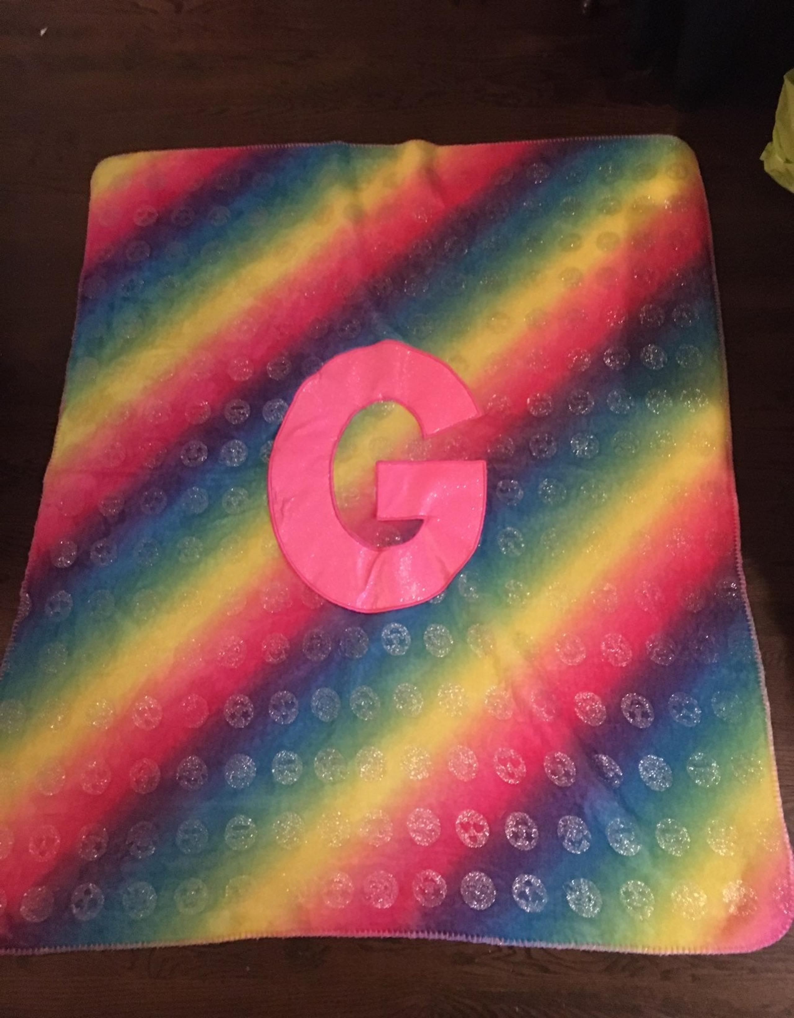 Justice G initial rainbow blanket