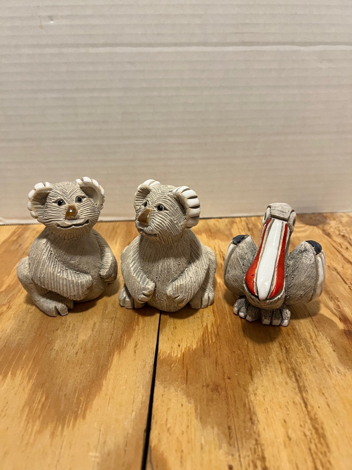 Signed koala bears and pelican made of stone