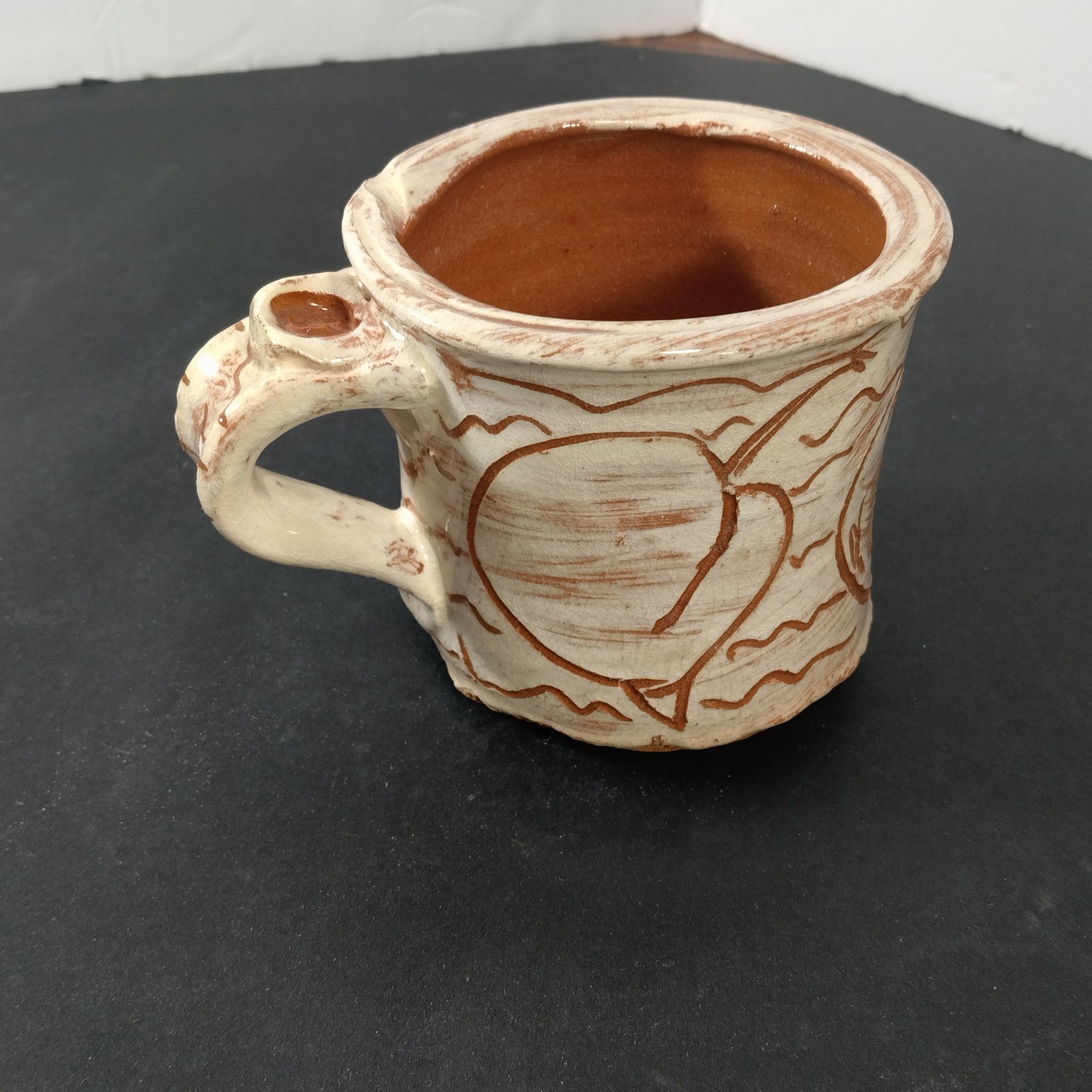 Hand Crafted mug stamped with apple on top of handle
