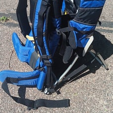 Kelty baby holding hiking backpack