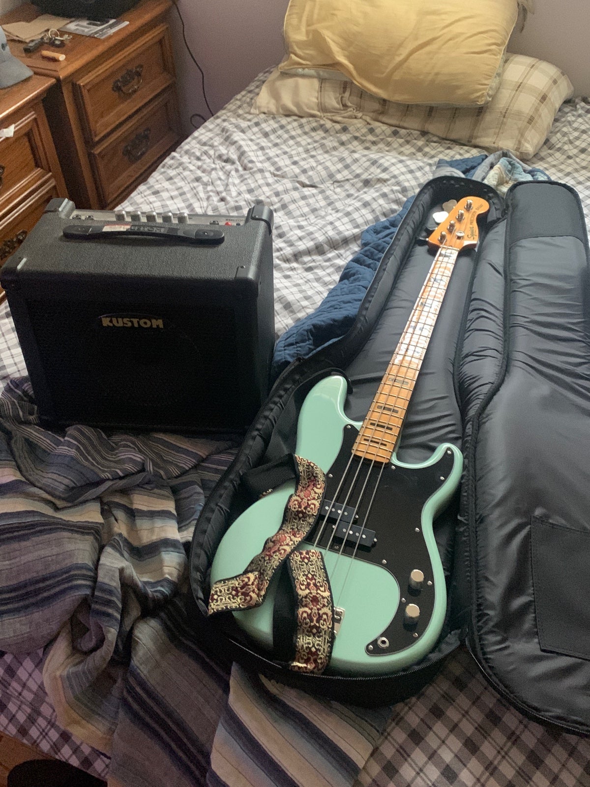bass guitar, carrying case, and an amp