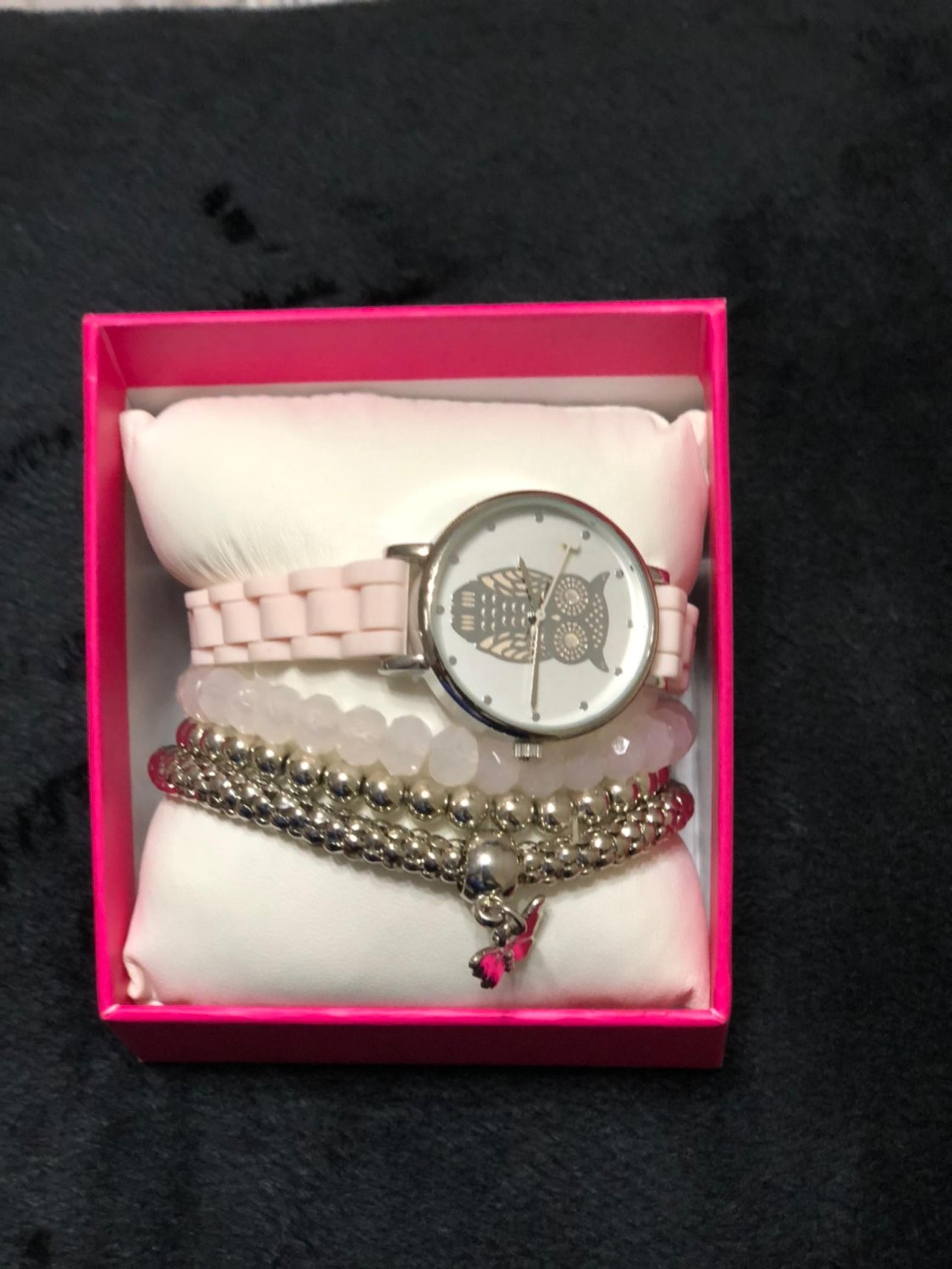 Pink watch with three bracelets