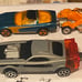 Four Hot wheel cars plus three miscellaneous