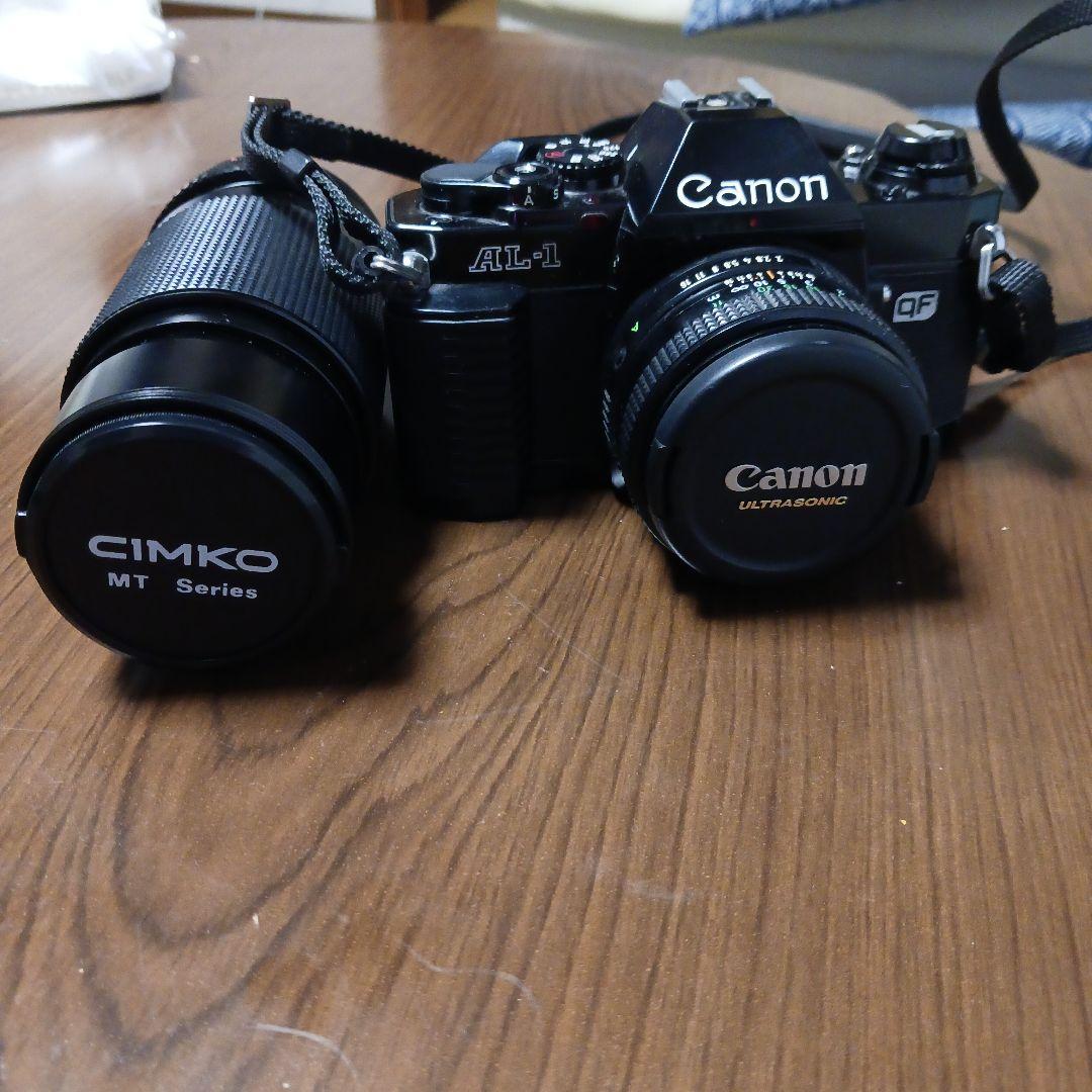 Canon AL-1 SLR camera with lens