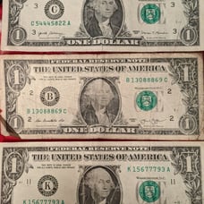 One dollar bills with triple bank note numbers
