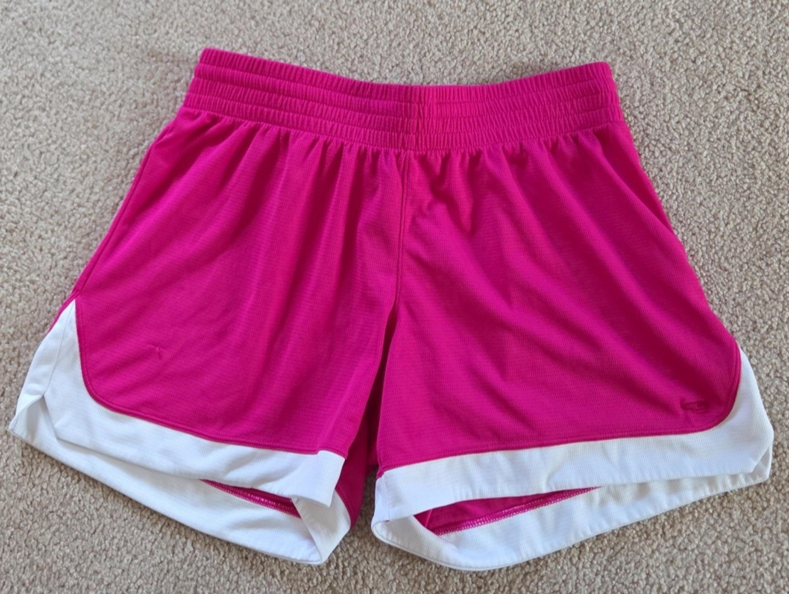 C9 by Champion running shorts, featuring a pink body with a white trim, drawstri