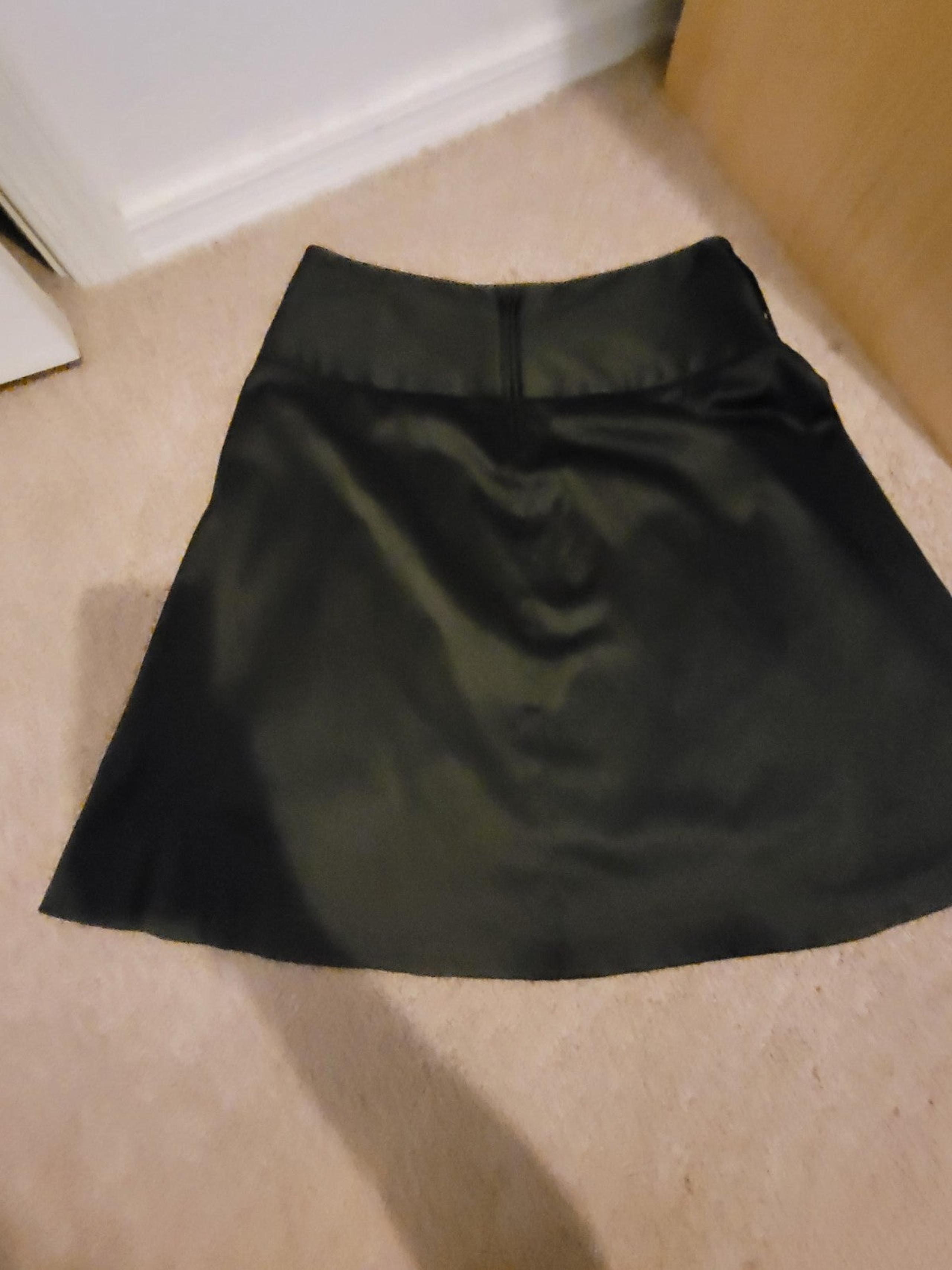 Black Satin like material skirt in great shape pleated