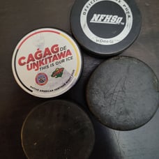 Hockey pucks in a lot of four