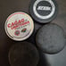 Hockey pucks in a lot of four