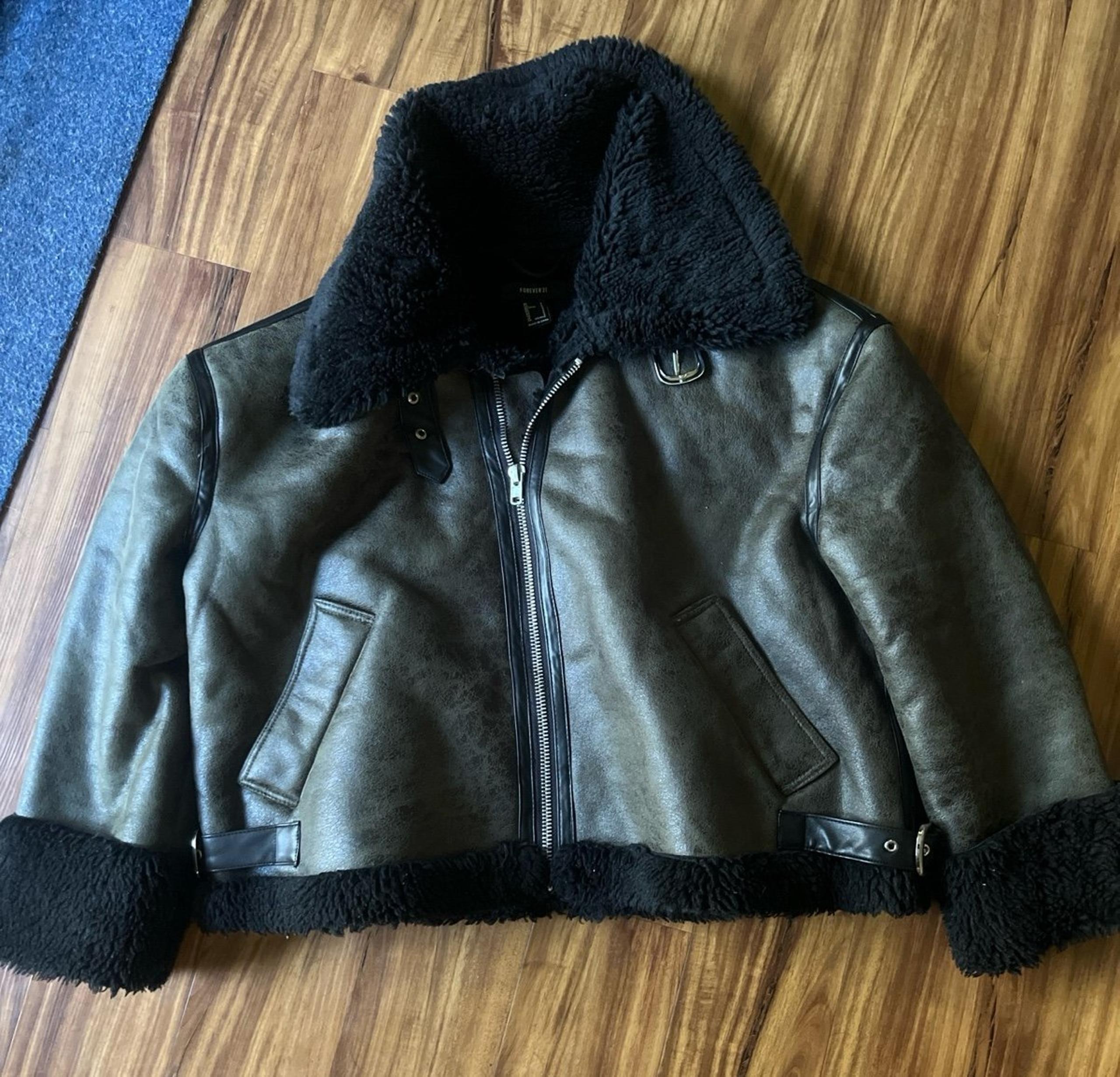 Forever 21 fleece interior jacket outside is like a green color with  with black