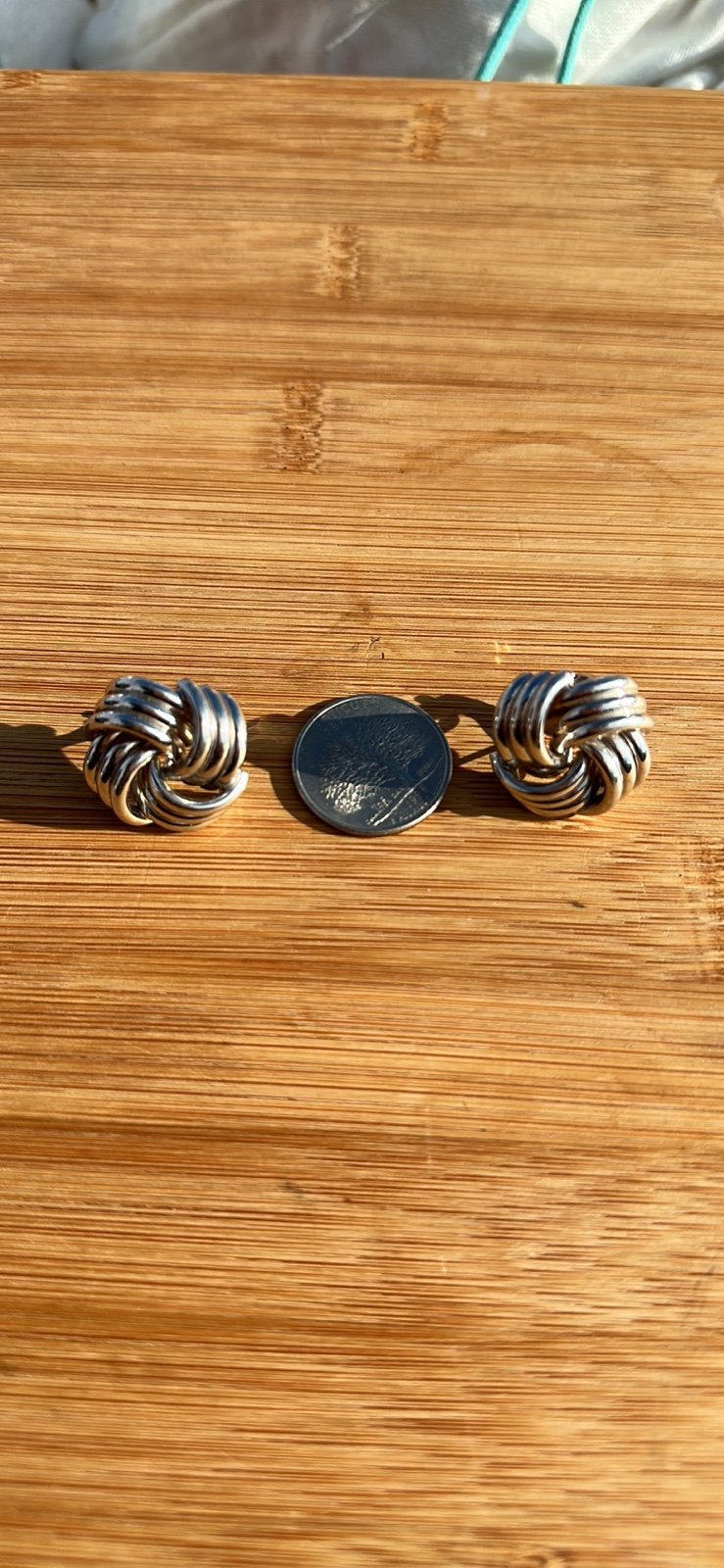 Vintage knot 14k white gold earring with a post back.