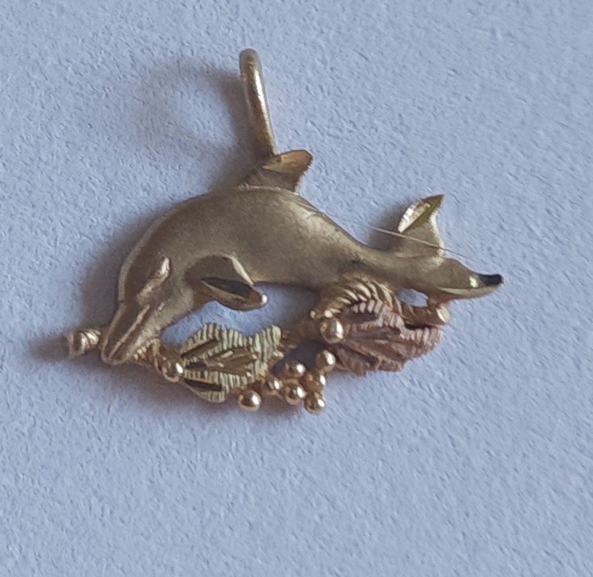 10k gold black hills gold dolphin pendant.