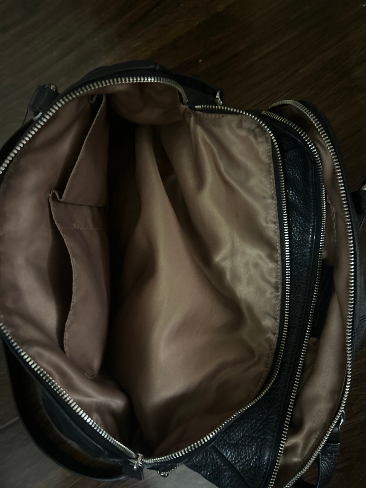 Used beautiful roomy with zipper pockets one removeable strap leaves