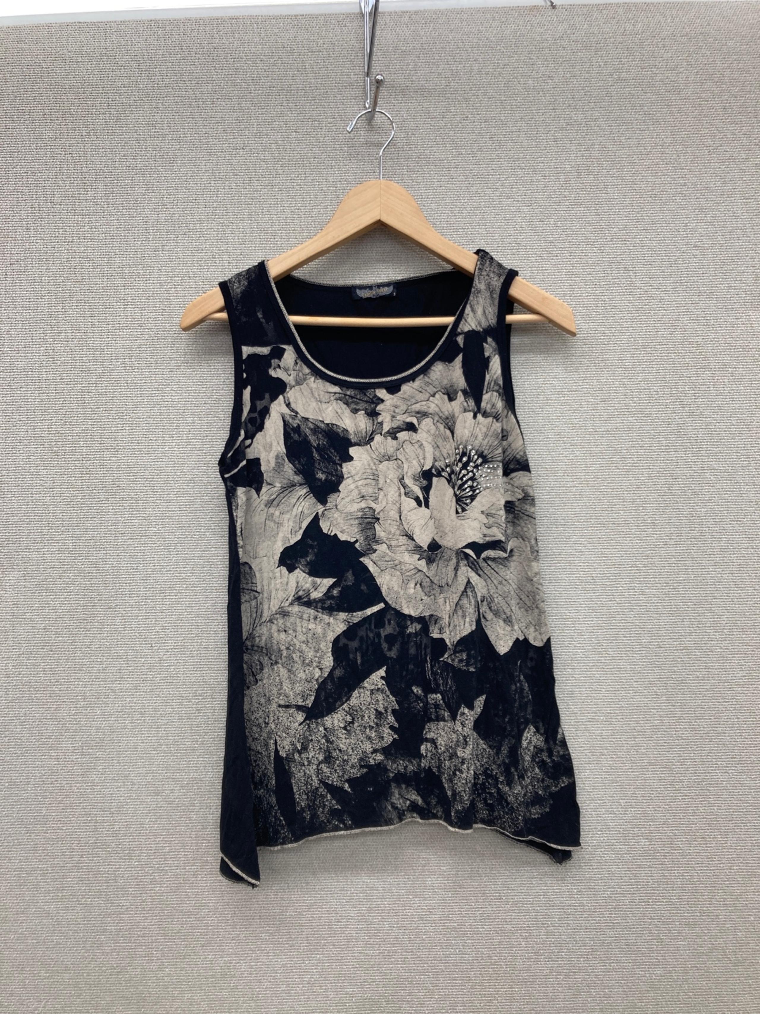 A Black and Tan Tank top with flowers all over the front.  Size small