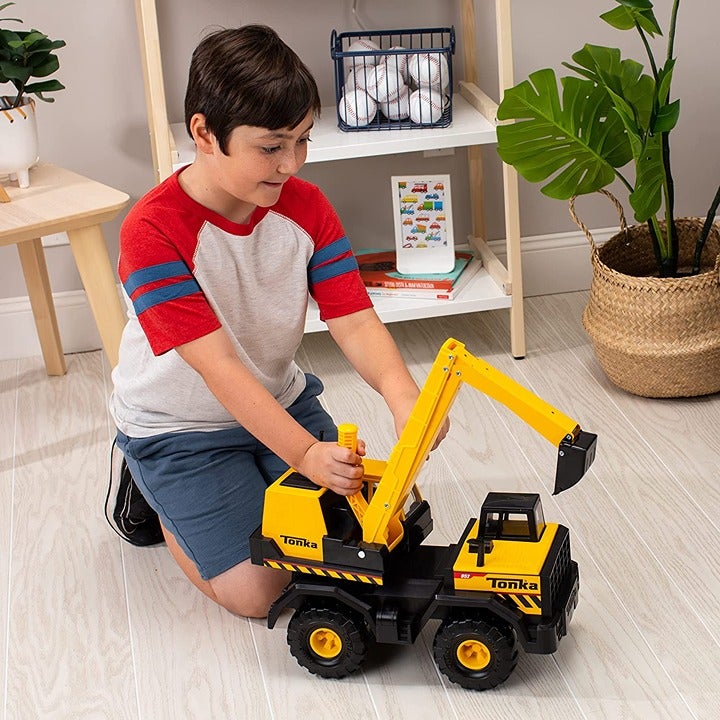 A child very like the heavy excavator toy