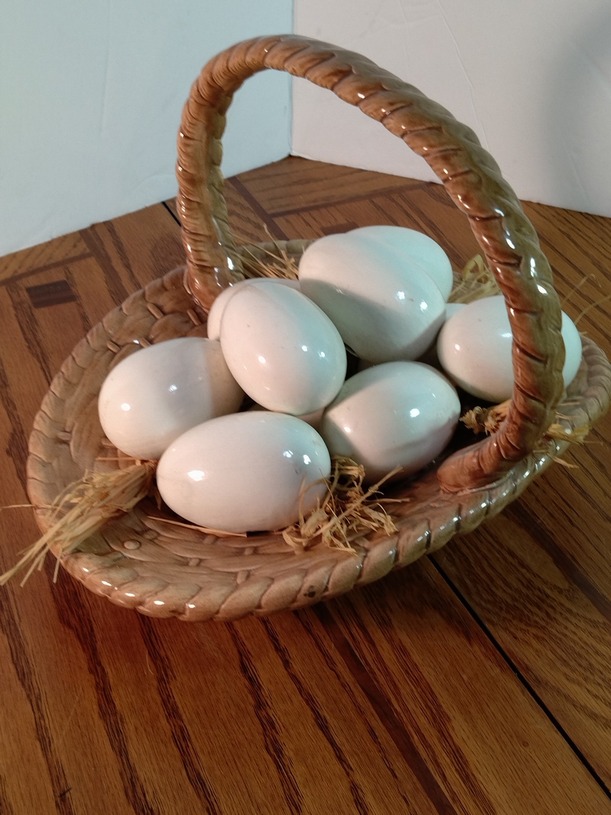 Hand made ceramic basket with 9 large ceramic eggs in it signed