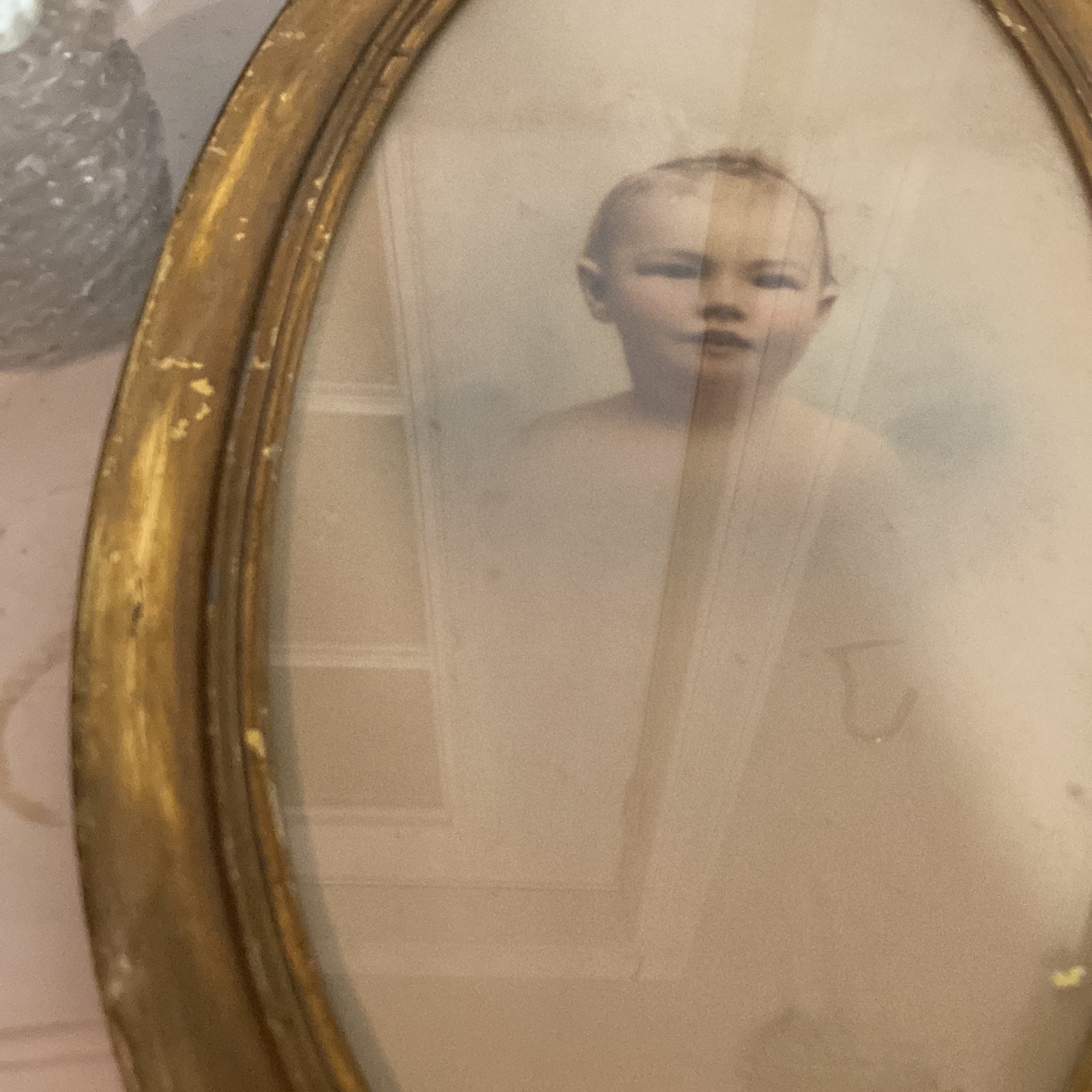 Art Noveau baby portrait in a gilded oval frame