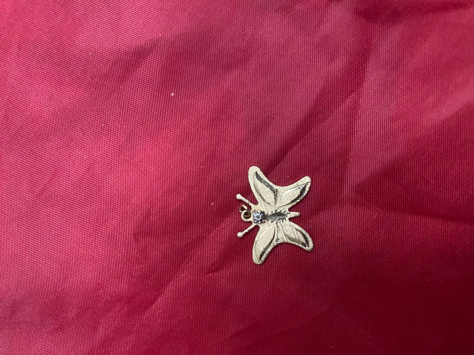 10k gold butterfly pendant with a small diamond in the middle