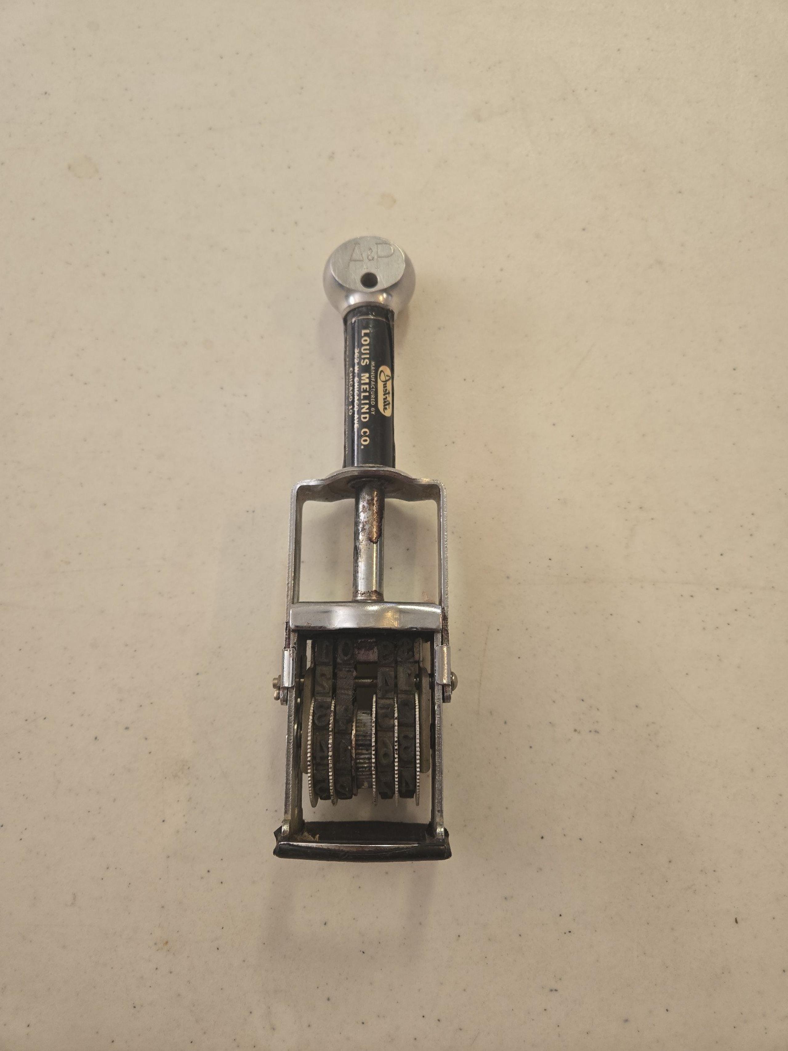 Louis Melind Co Justrite Metal Stamp