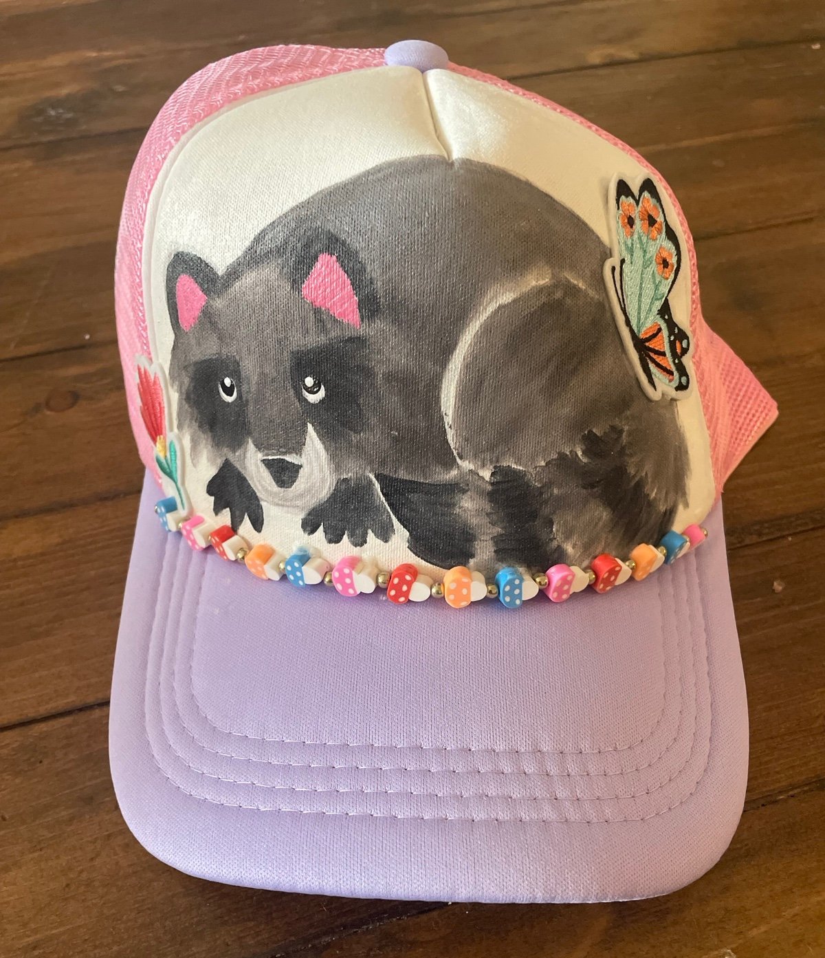Handpainted raccoon with itches and mushroom beading trucker hat