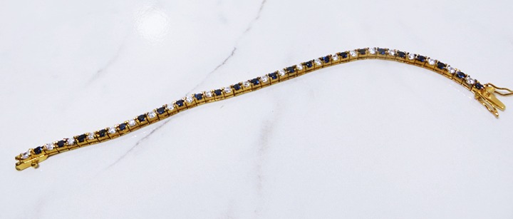 Mesmering Blue Sapphire & Accent Yellow Gold Over Sterling Tennis Bracelet