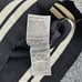 NWT INC Women's M Black Varsity Wt Pearl ADORN Asymmetrical Long Sleeve Sweater