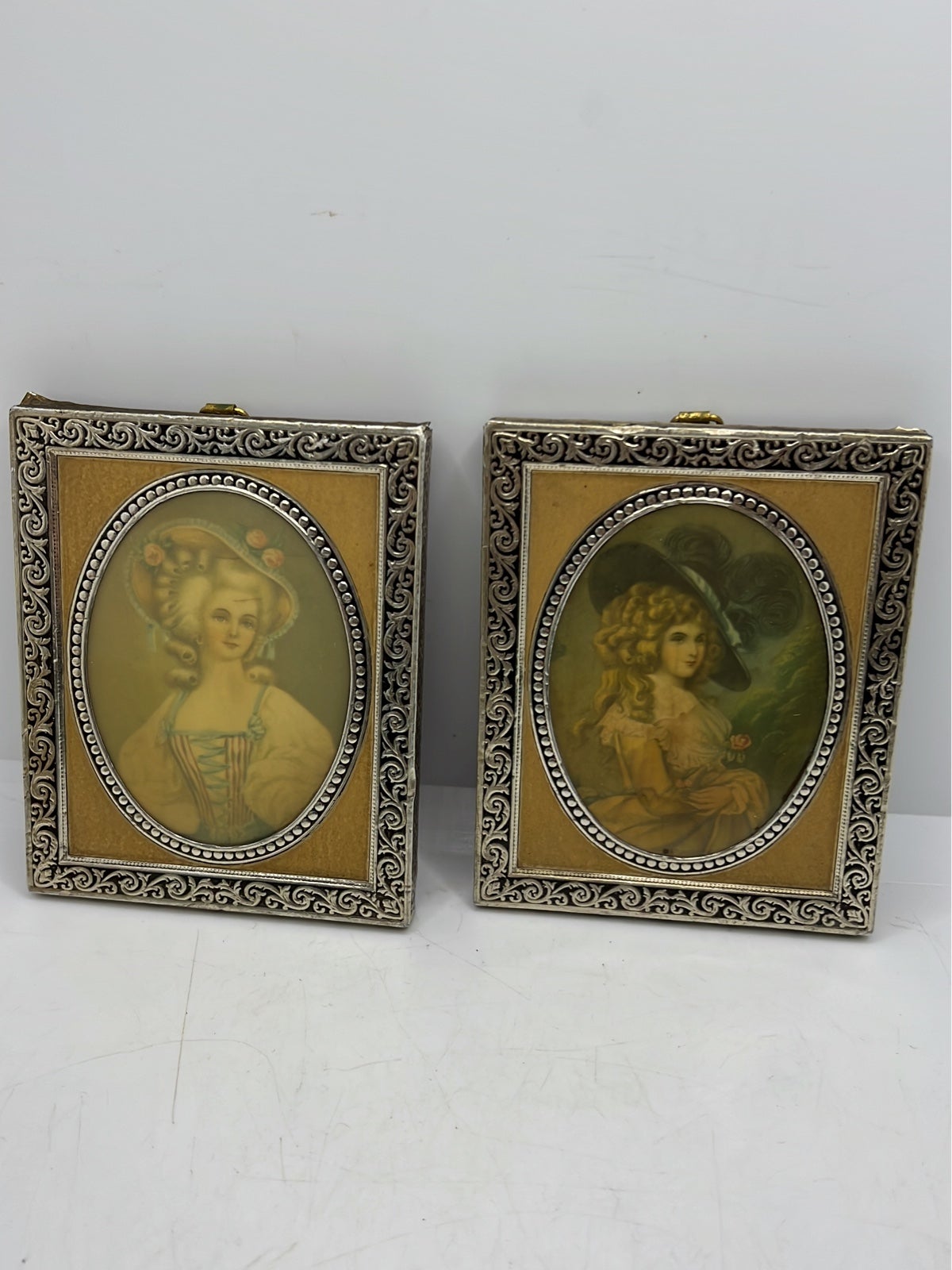 Two vintage prints on ceramic cameos on wooden block
