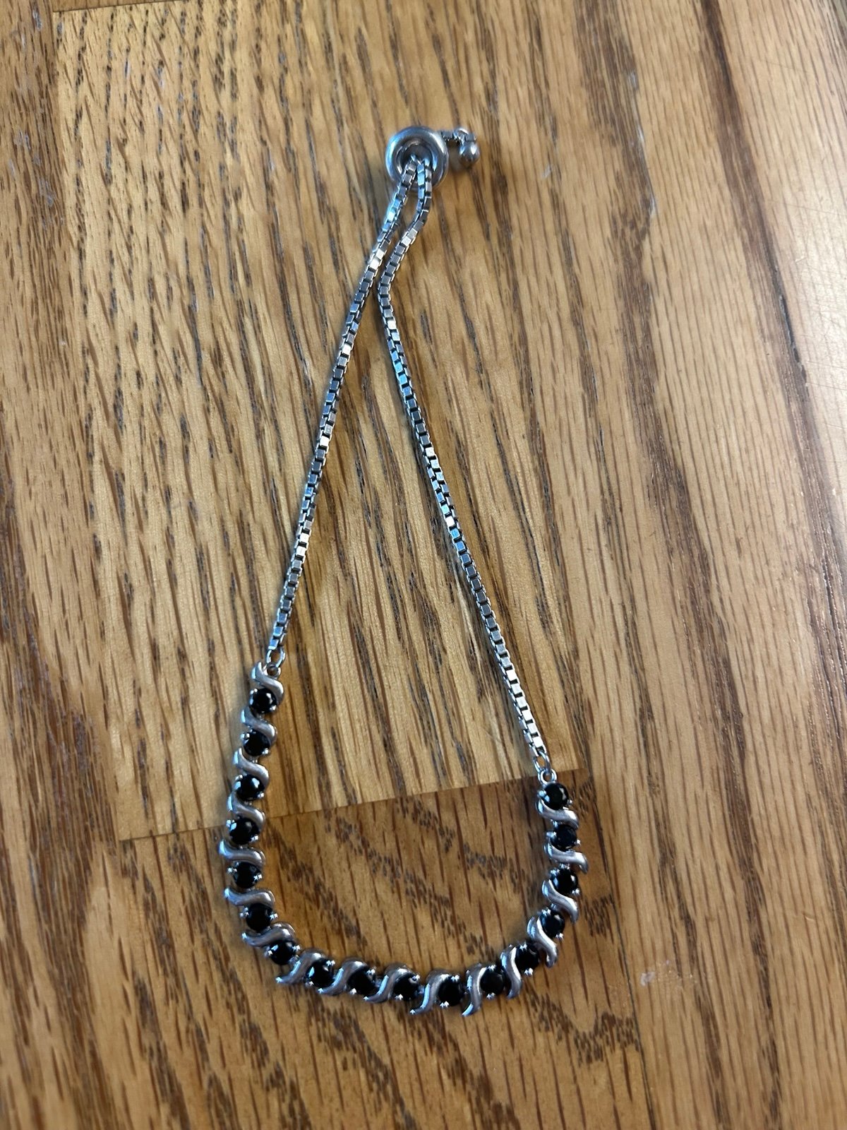 Bracelet sterling silver. Adjustable with dark blue sapphire stones.