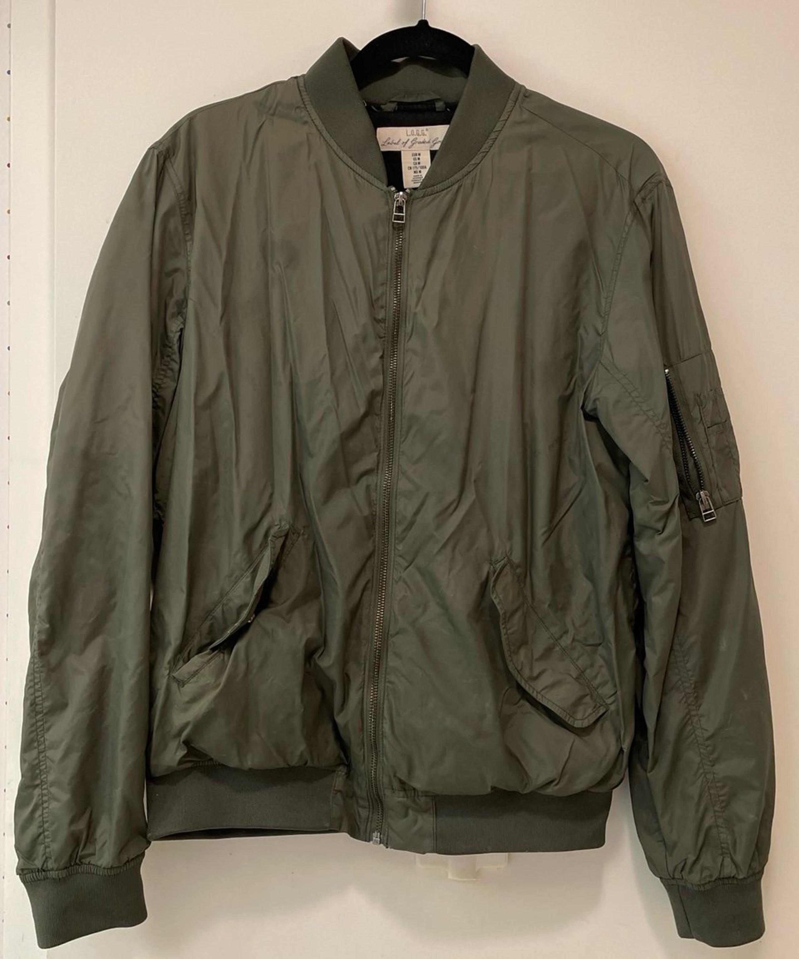 Green bomber jacket with lots of pockets