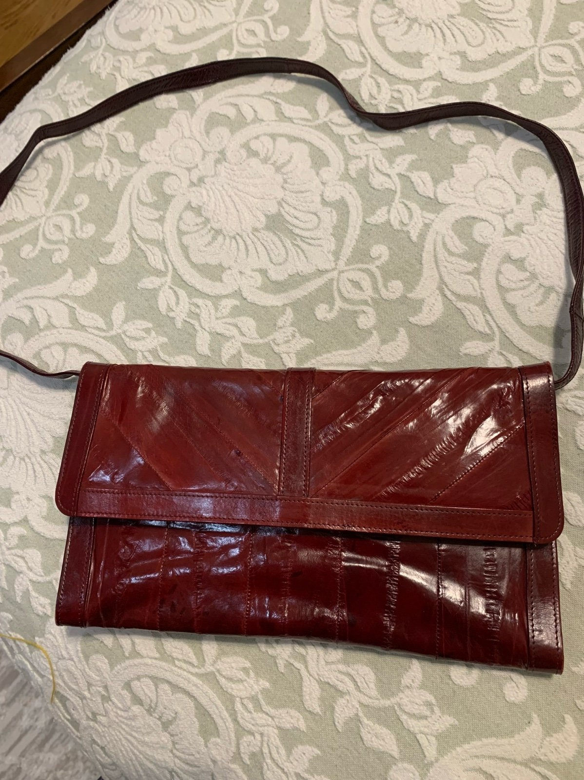 NWOT Eel Skin Wine Burgundy Clutch with thin strap. Has compartments.Unbrande