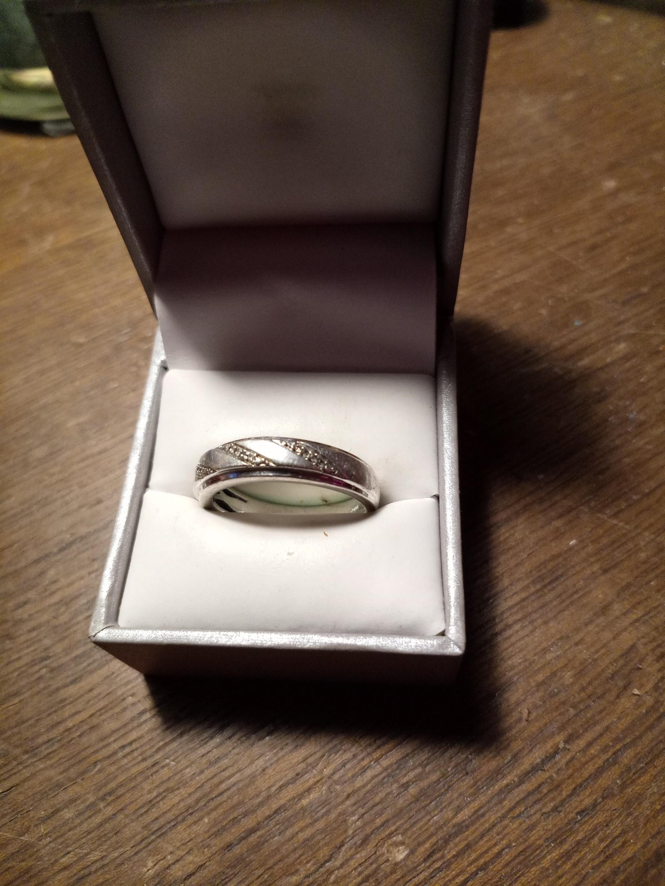Sterling and diamond ring about 1/2 carrot. With 12 small diamonds.set in silver