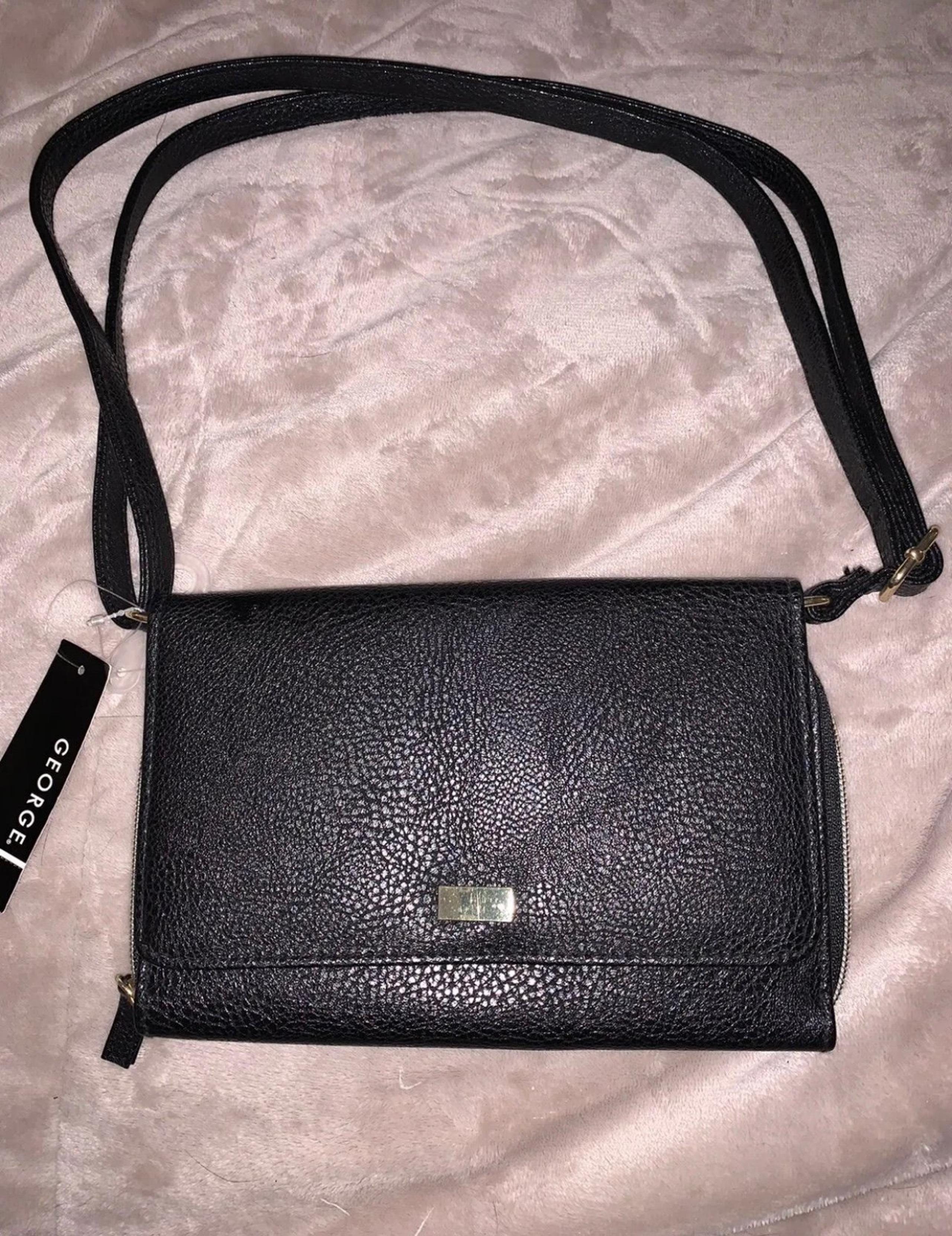 Black organizer wallet crossbody. Black faux Leather.. Condition new with tags.