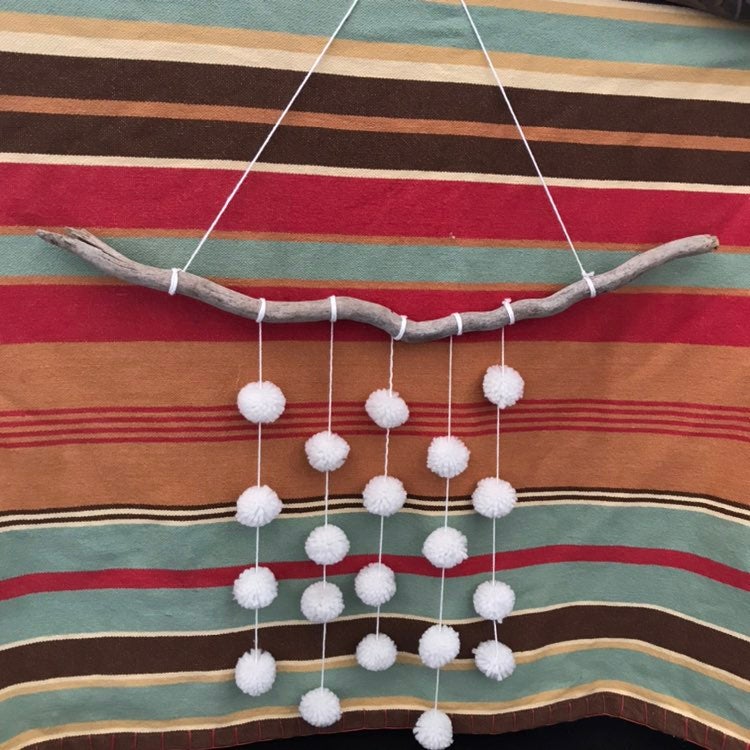 Driftwood pom pom wall decor