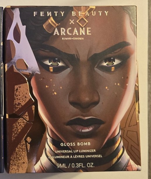 Fenty Beauty x Arcane gloss bomb universal lip Risky Rulin' shimmering warm gold