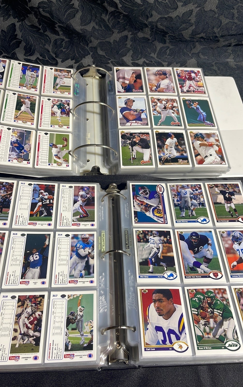 Binders of baseball/football cards over 2000 cards. Trading cards